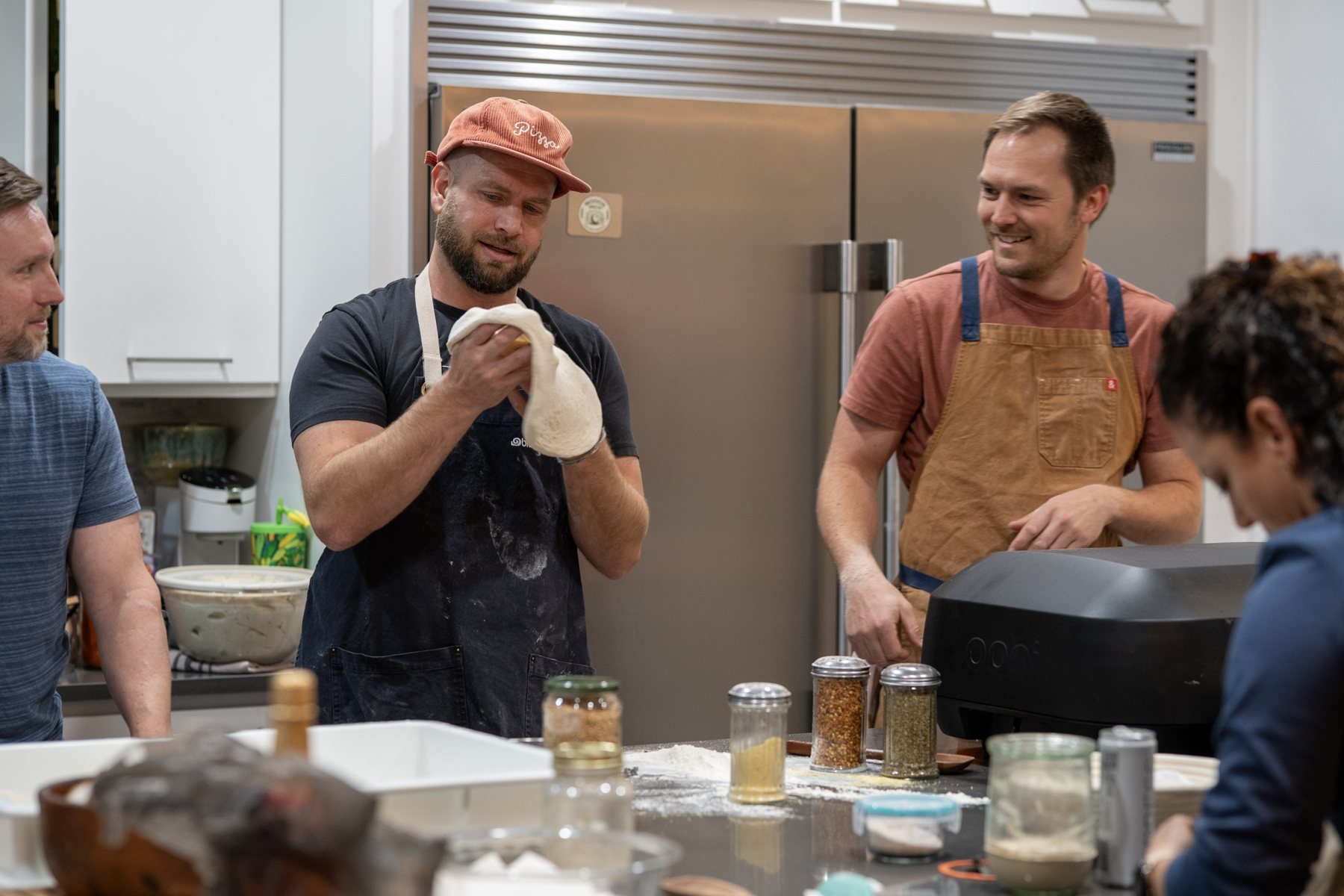 Jordan and workshop participants handling sourdough together in the kitchen