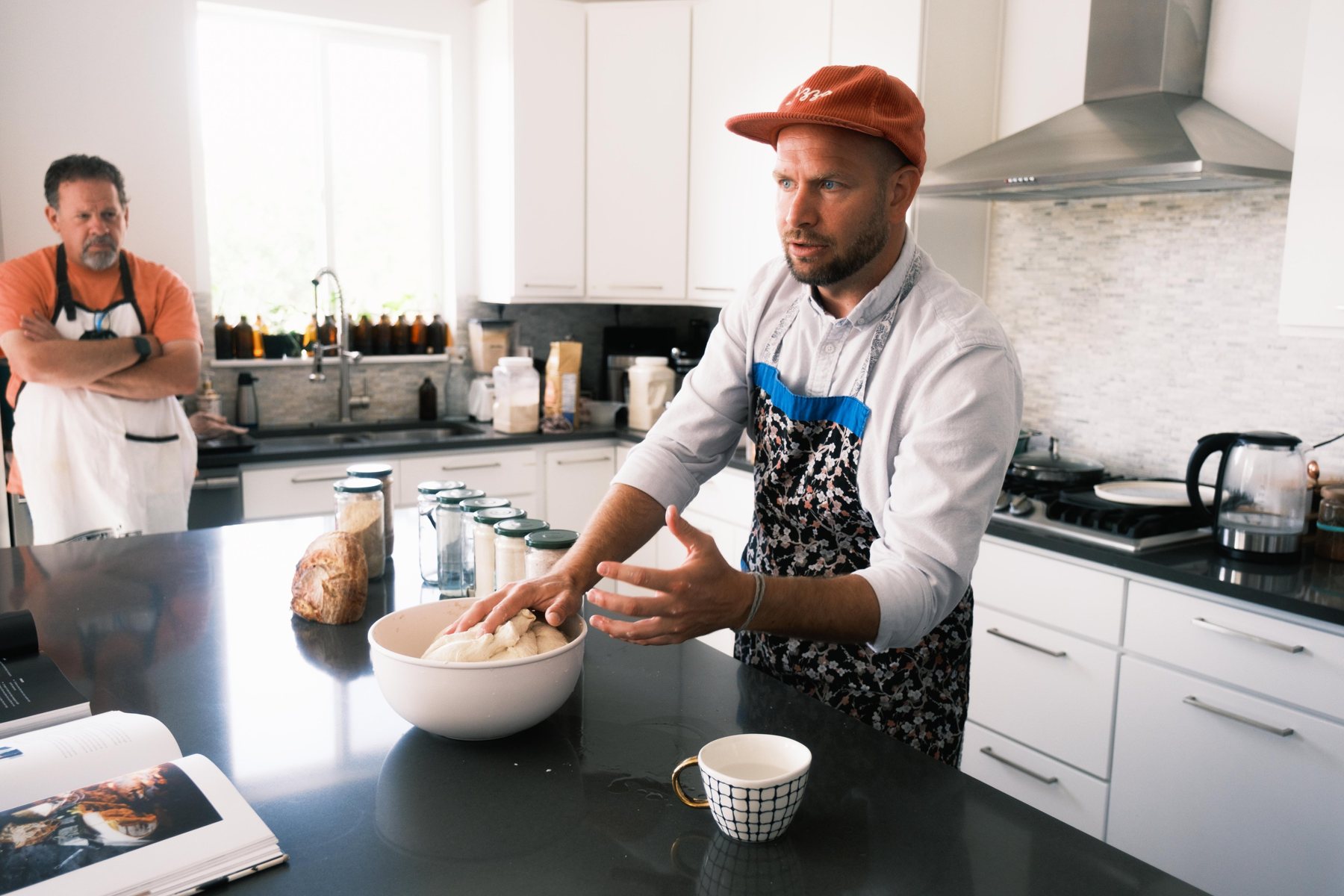 Jordan Davis explaining sourdough dough in his kitchen during a workshop